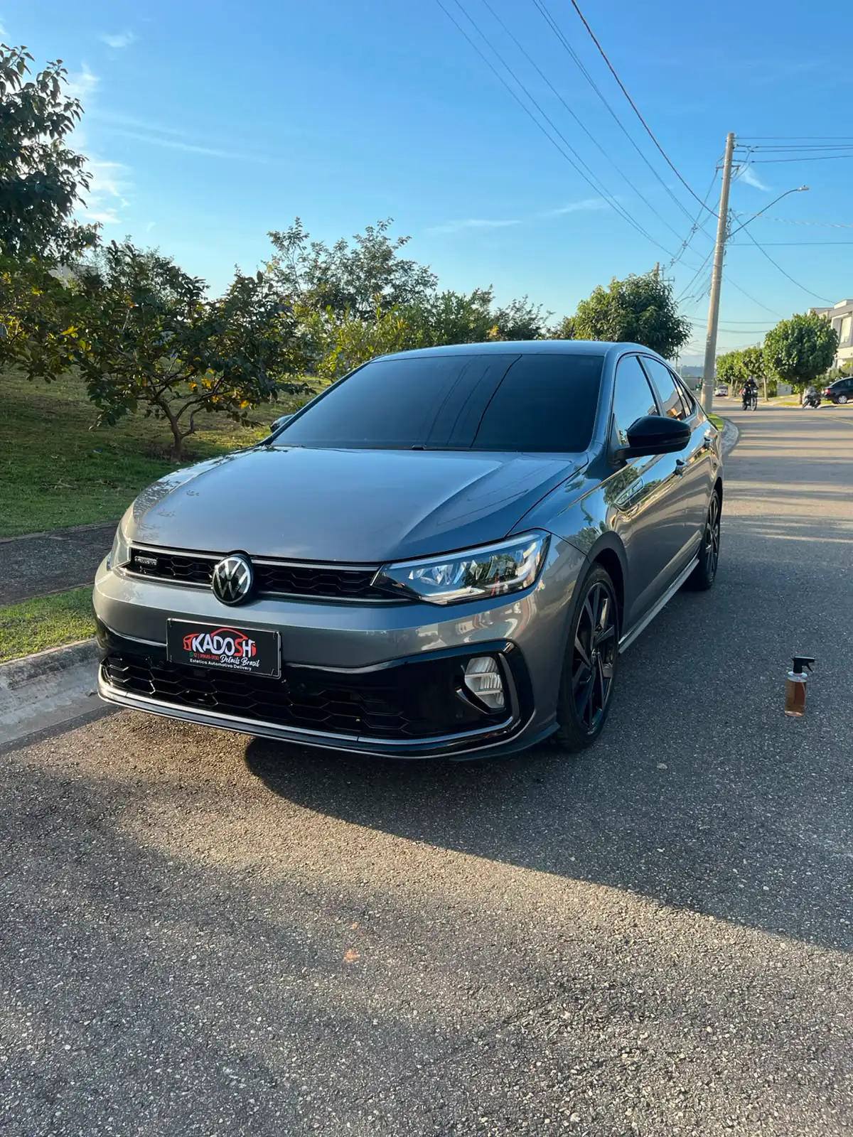 Sedan cinza com acabamento premium após lavagem delivery